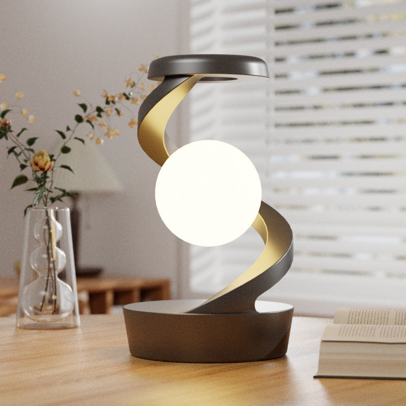 The Orbivolt™ Rotating Wireless Charging Lamp